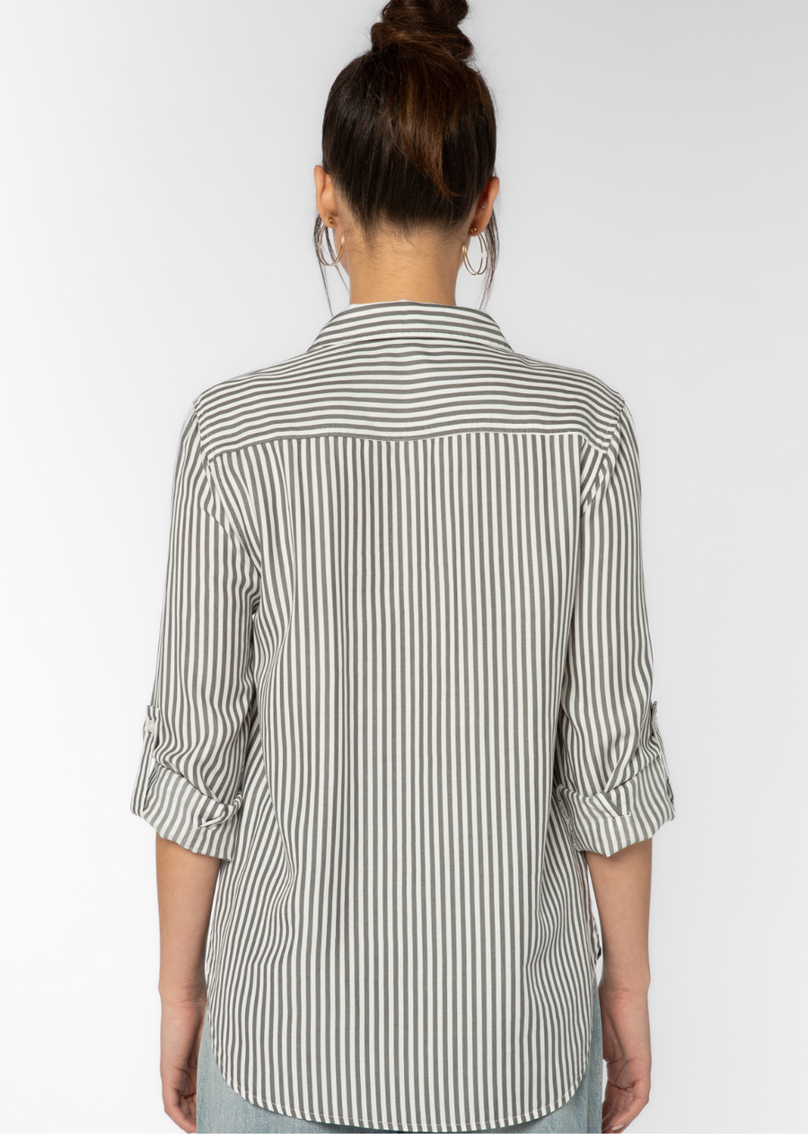 Velvet Heart Talma Shirt- Charcoal Stripe. The Talma Shirt features roll tab sleeves, a button front, flap chest pockets, and a slight high-low hem. This eco-friendly shirt drapes comfortably providing an effortless, casual fit.