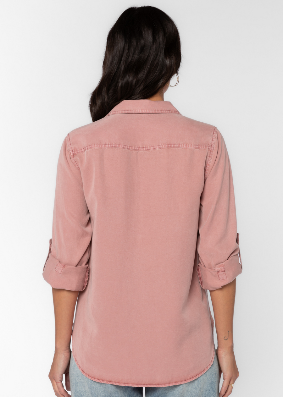 Velvet Heart Talma Shirt- Muted Mauve. This shirt features roll tab sleeves, a button front, flap chest pockets, and a slight high-low hem. This eco-friendly shirt drapes comfortably providing an effortless, casual fit.