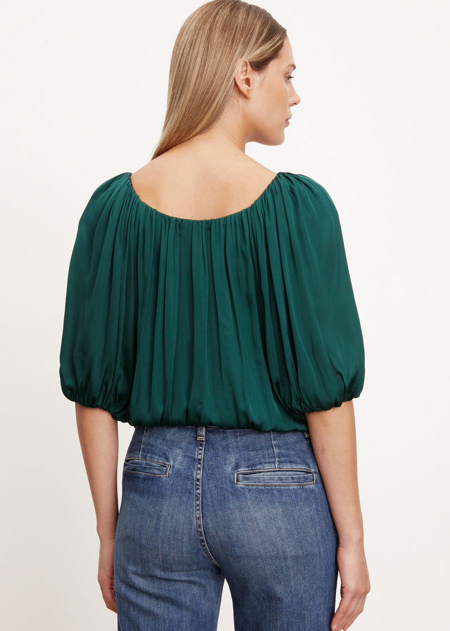 Velvet Tami Satin Top. Crafted from satin viscose with a subtle sheen, this cropped top features exaggerated puff sleeves for a bold and modern look. The elastic neckline, cuffs, and hem offer versatile styling, allowing you to wear it on or off the shoulder.