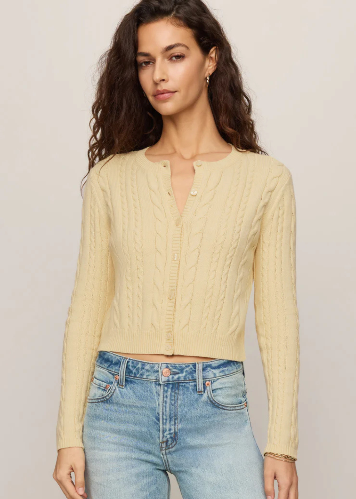 A cable knit cardigan made for easy layering on cool summer nights.