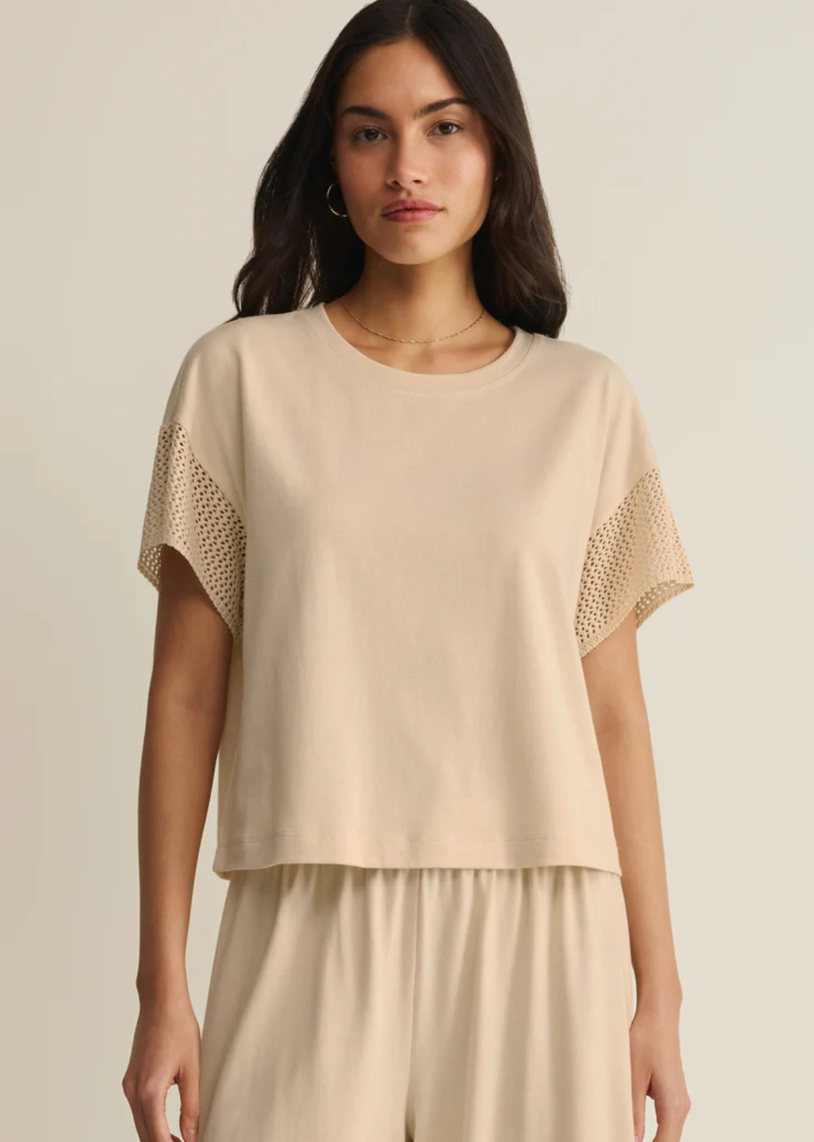 This relaxed cotton-blend short sleeve t-shirt gets a feminine update with crochet-inspired knit sleeves. Lightweight and easy with a classic crew neckline, it's the perfect laid-back style for warm days.