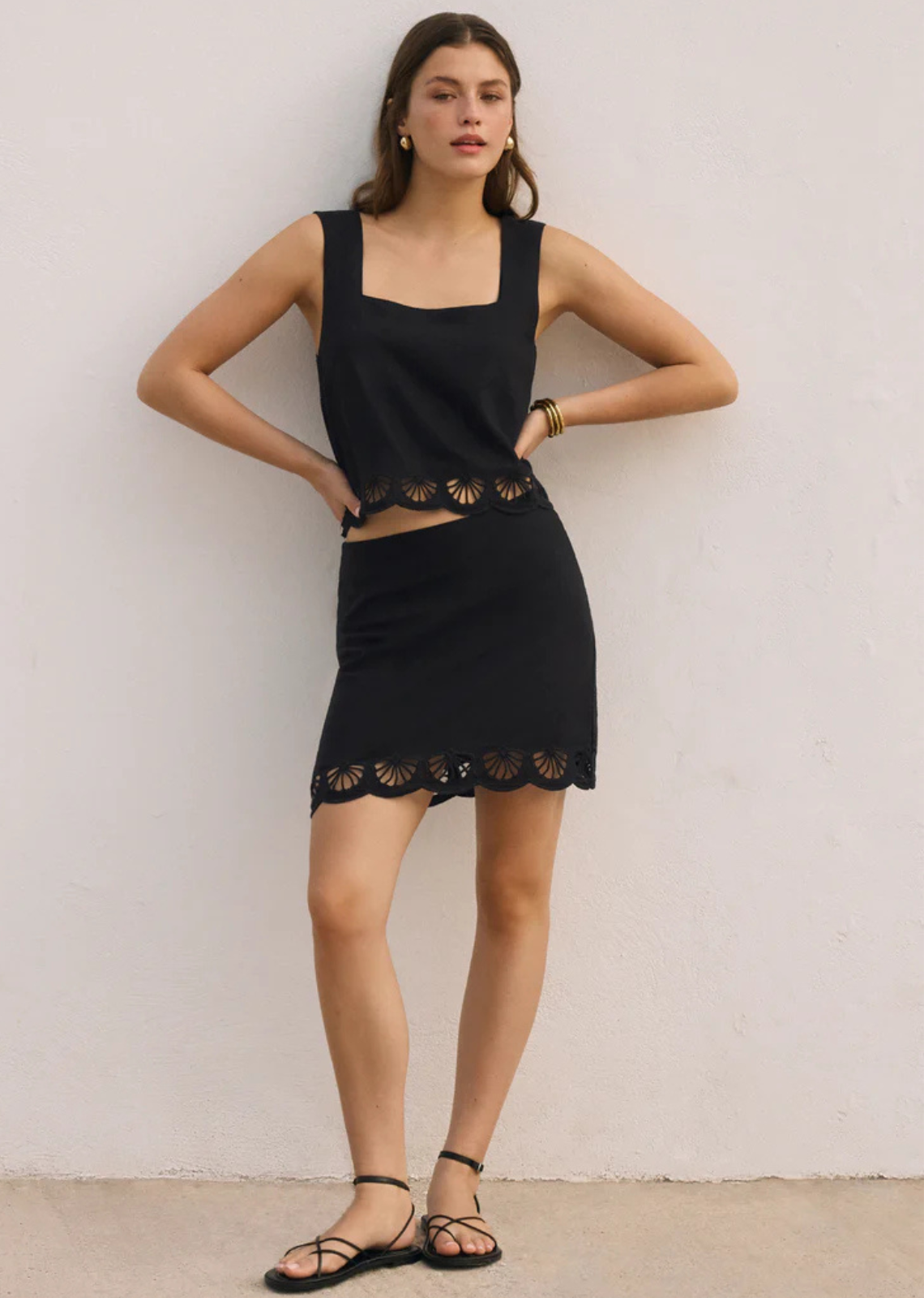 Crafted in an airy washed linen fabric, this mini skirt features delicate shell cut-out embroidery and a scalloped hem. Pair it with the matching top for a polished warm-weather co-ord skirt set.
