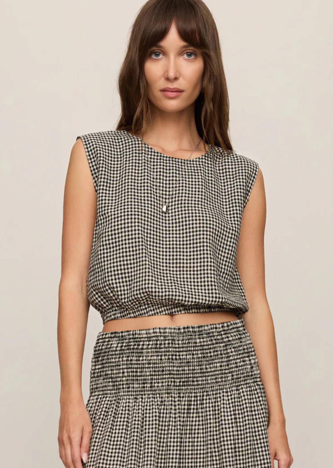 Made from a lightweight linen blend with a soft, textured feel and natural drape, this style features an elasticated hem that creates that signature shape. A button closure at the back neckline keeps the finish clean and minimal. Layer it under your favorite knit or pair it with the matching skirt and boots for the perfect fall outfit.