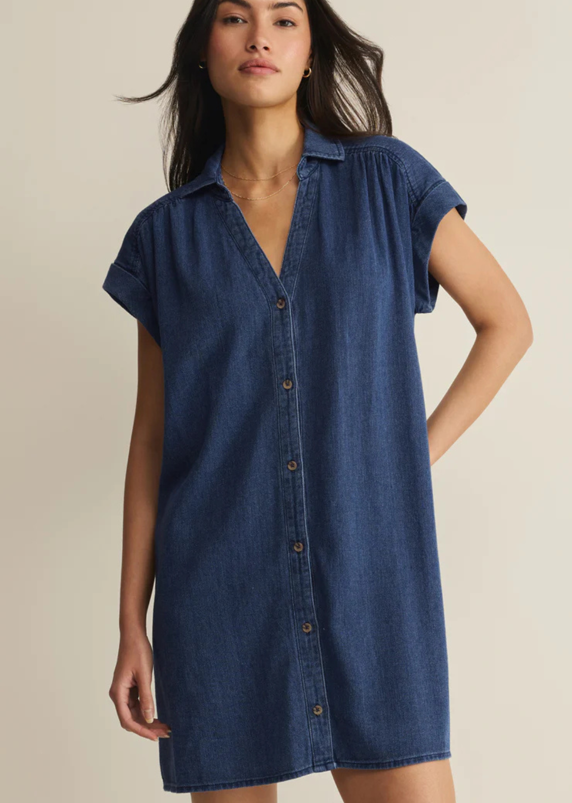 Made from soft cotton twill with a denim-inspired feel, this mini shirt dress features a camp collar, tonal buttons, and gathered shoulder details. The relaxed silhouette keeps it comfortable and effortless for everyday wear.