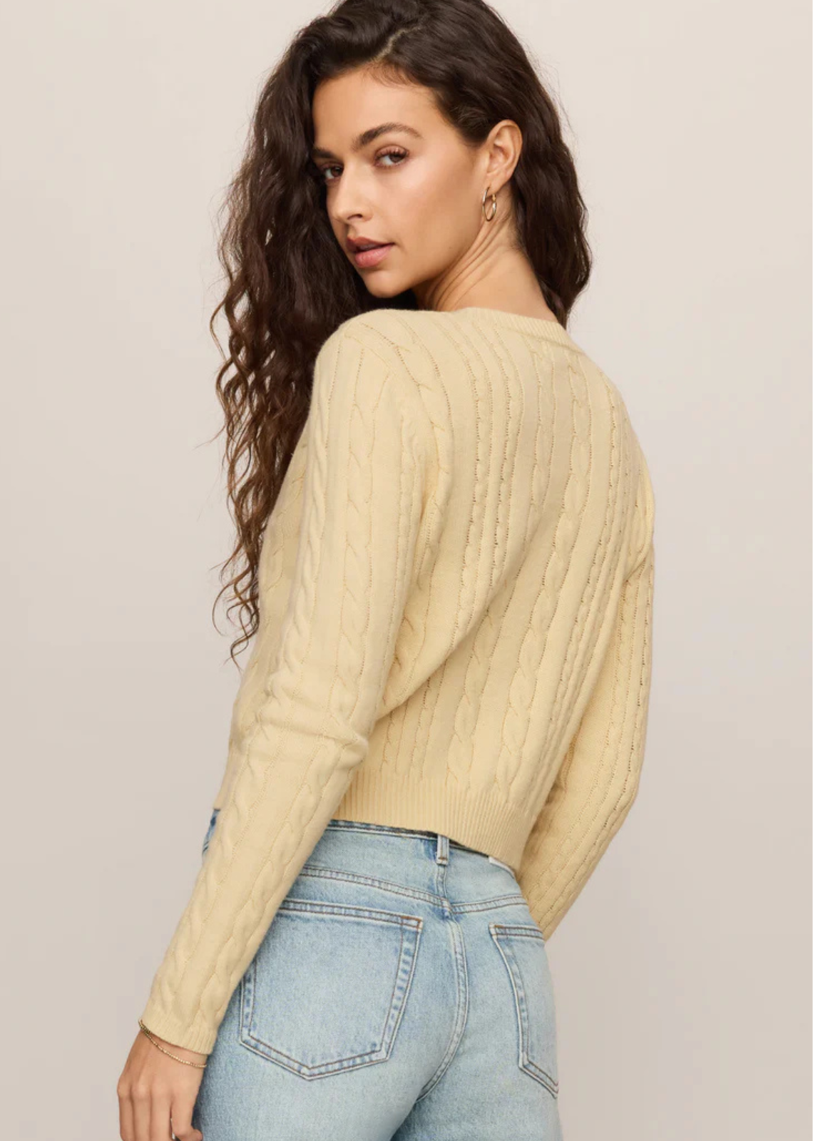 A cable knit cardigan made for easy layering on cool summer nights.