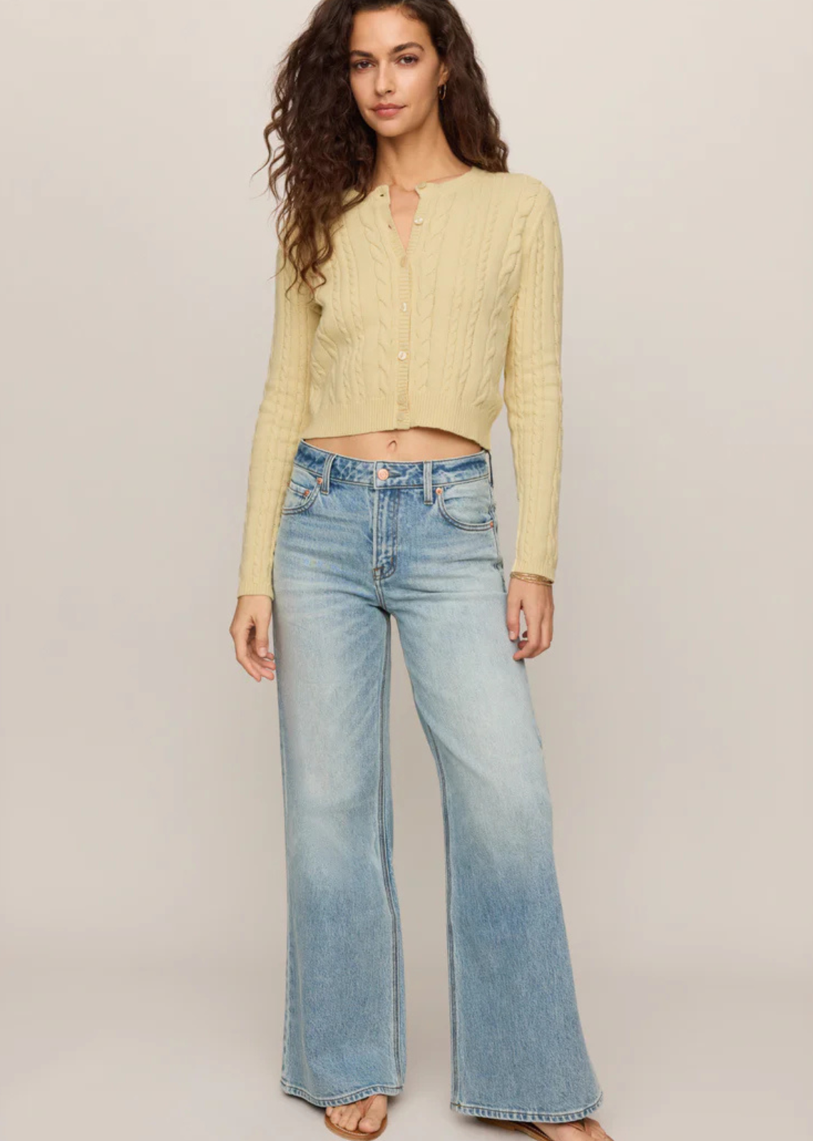 A cable knit cardigan made for easy layering on cool summer nights.