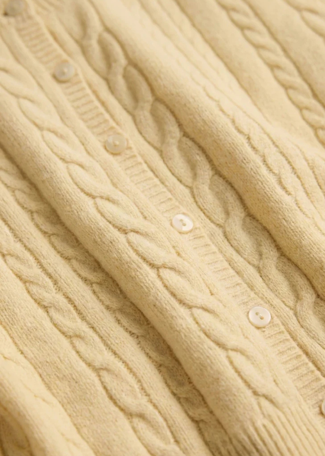 A cable knit cardigan made for easy layering on cool summer nights.