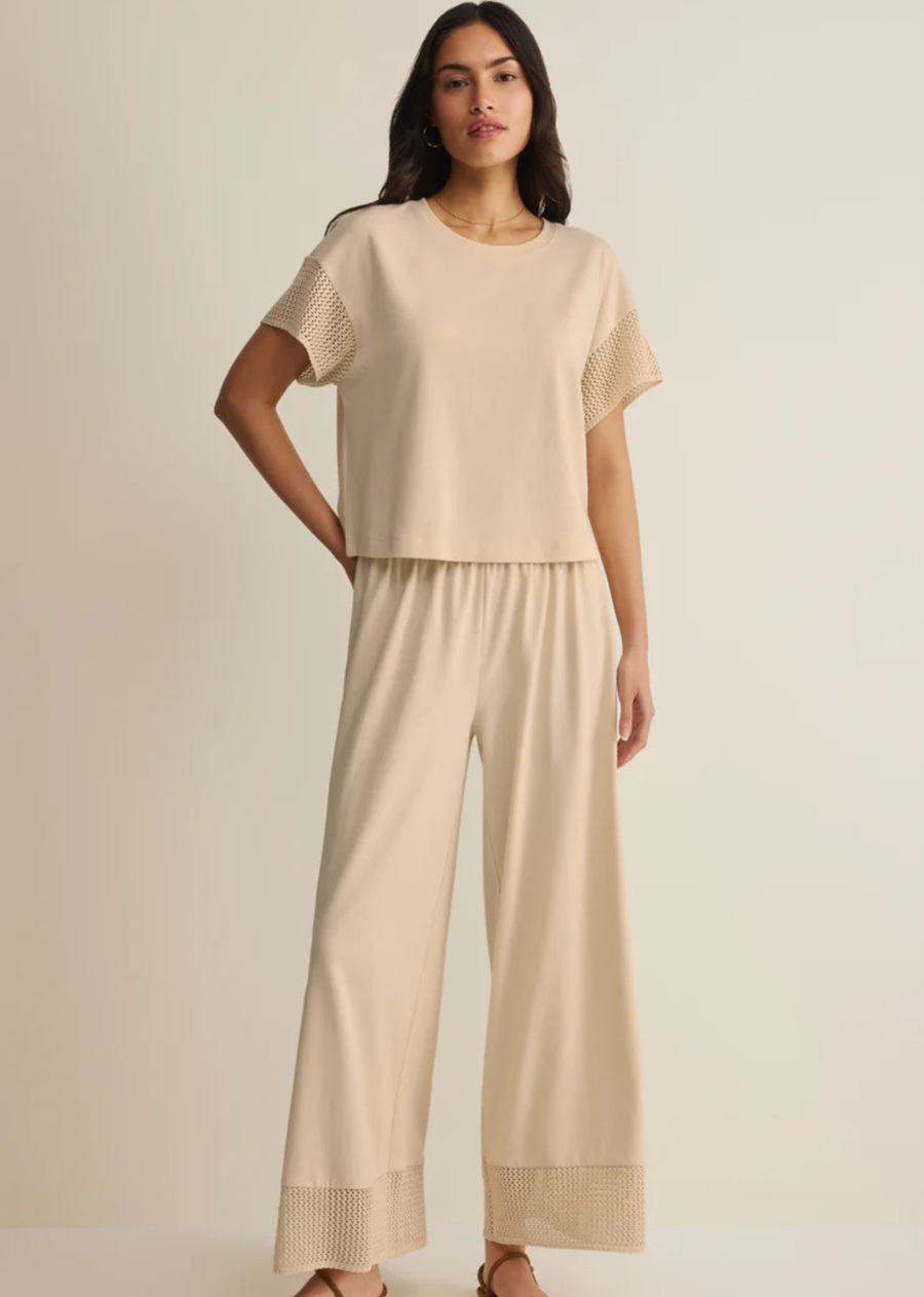 This relaxed cotton-blend short sleeve t-shirt gets a feminine update with crochet-inspired knit sleeves. Lightweight and easy with a classic crew neckline, it's the perfect laid-back style for warm days.