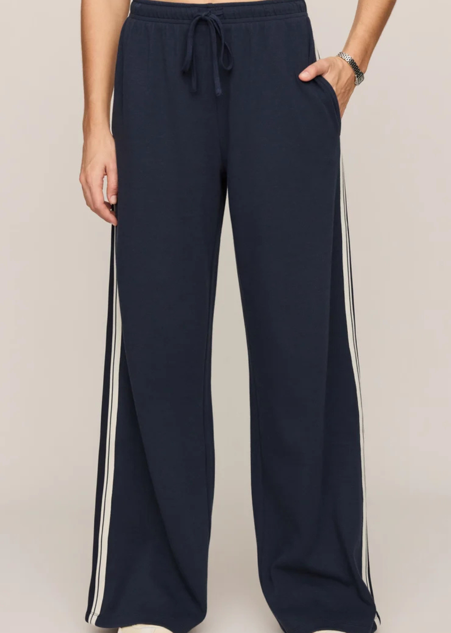Track pants just feel different in the fall. Made from a soft sleek knit with an easy relaxed drape, this pair brings all the sporty energy everyone’s craving right now while still feeling elevated enough for everyday plans. Pair with oversized sweatshirts, knits, and the sneakers you refuse to retire yet.