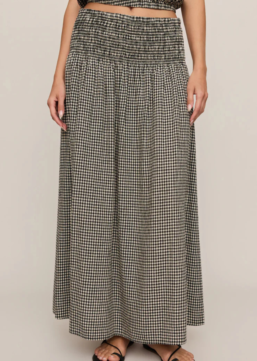 There’s something about this gingham skirt that just makes getting dressed feel lighter. The unlined, lightweight fabric moves as you walk, giving it that effortless flow, while the smocked waistband keeps everything comfortable. Perfect for every day and beyond. Pair with your favorite knit or the matching top.