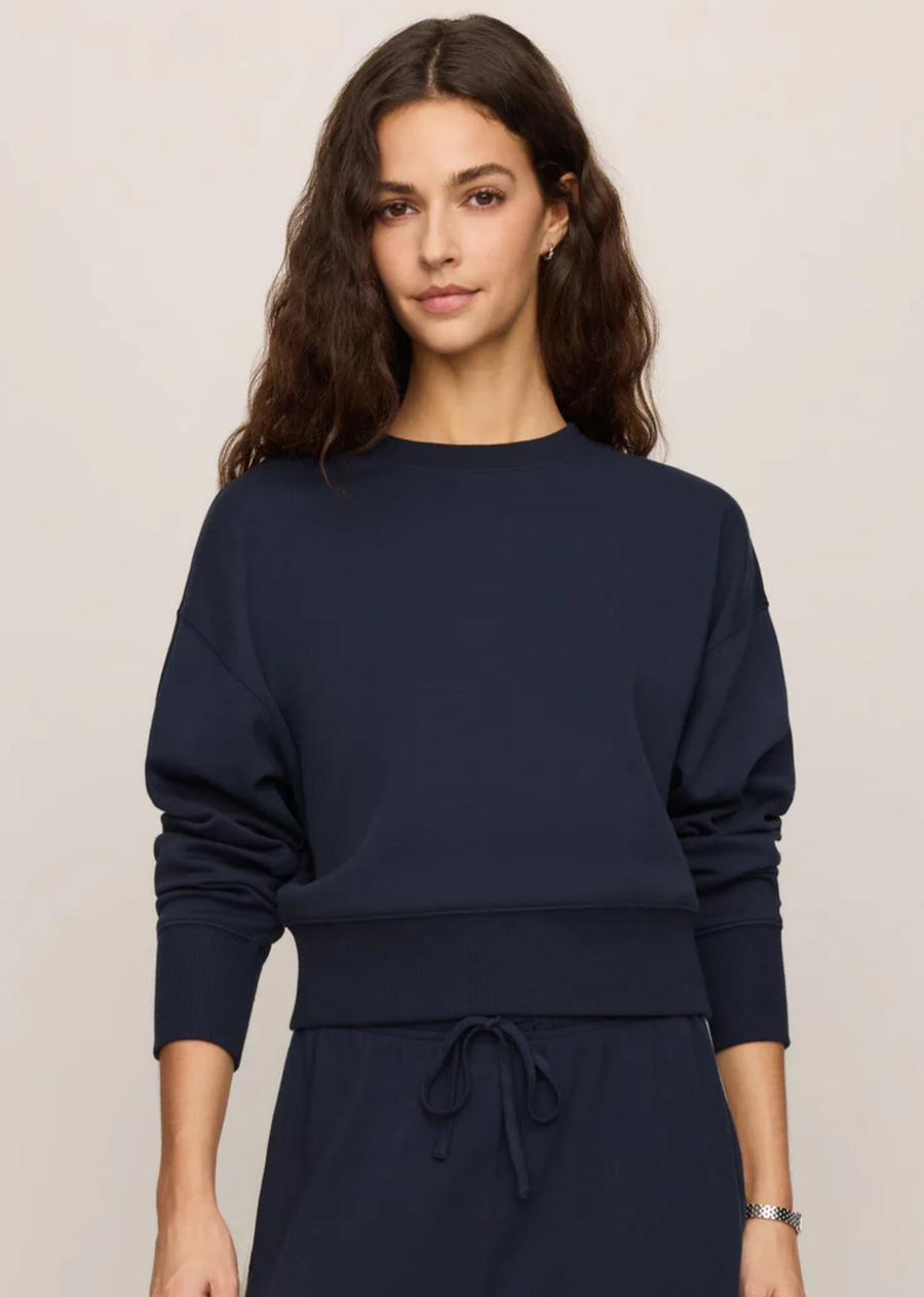 Made from a soft smooth knit with a relaxed fit and dropped shoulders, this sweatshirt brings a cleaner more elevated feel to everyday comfort. Pair it with the matching pants for the kind of sporty set you’ll keep reaching for all season long.