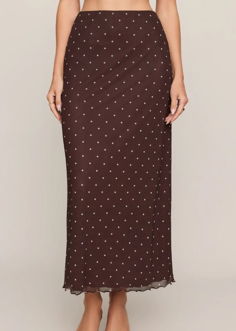 A mesh midi skirt with soft stretch, subtle movement, and the kind of silhouette that quietly makes outfits better. Tiny polka dots and a lettuce-edge hem add just enough texture and nostalgia, while the fully lined fit keeps it easy from the second you put it on. Pair it with the matching top for a look that gets a lot of “wait, where’d you get that?” questions.