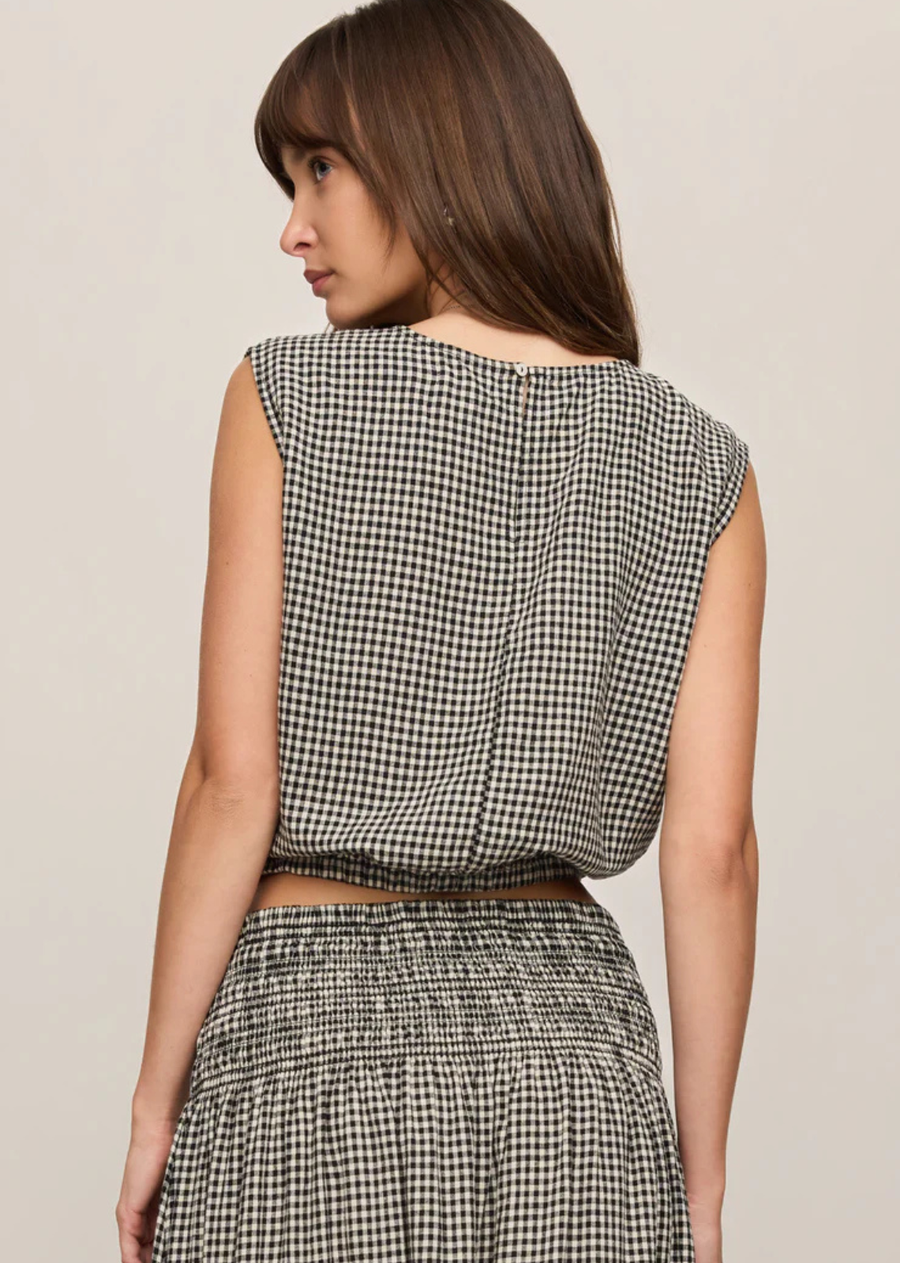 Made from a lightweight linen blend with a soft, textured feel and natural drape, this style features an elasticated hem that creates that signature shape. A button closure at the back neckline keeps the finish clean and minimal. Layer it under your favorite knit or pair it with the matching skirt and boots for the perfect fall outfit.