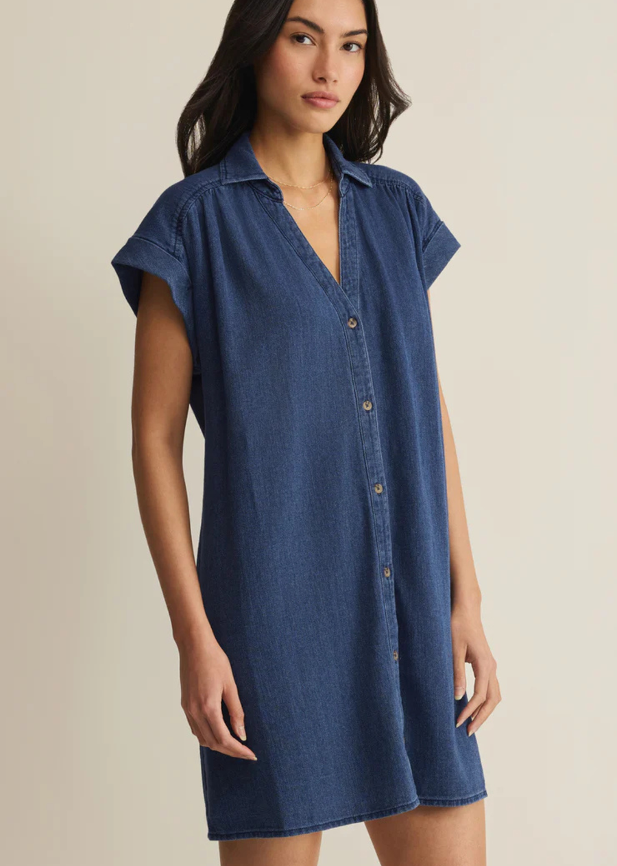 Made from soft cotton twill with a denim-inspired feel, this mini shirt dress features a camp collar, tonal buttons, and gathered shoulder details. The relaxed silhouette keeps it comfortable and effortless for everyday wear.