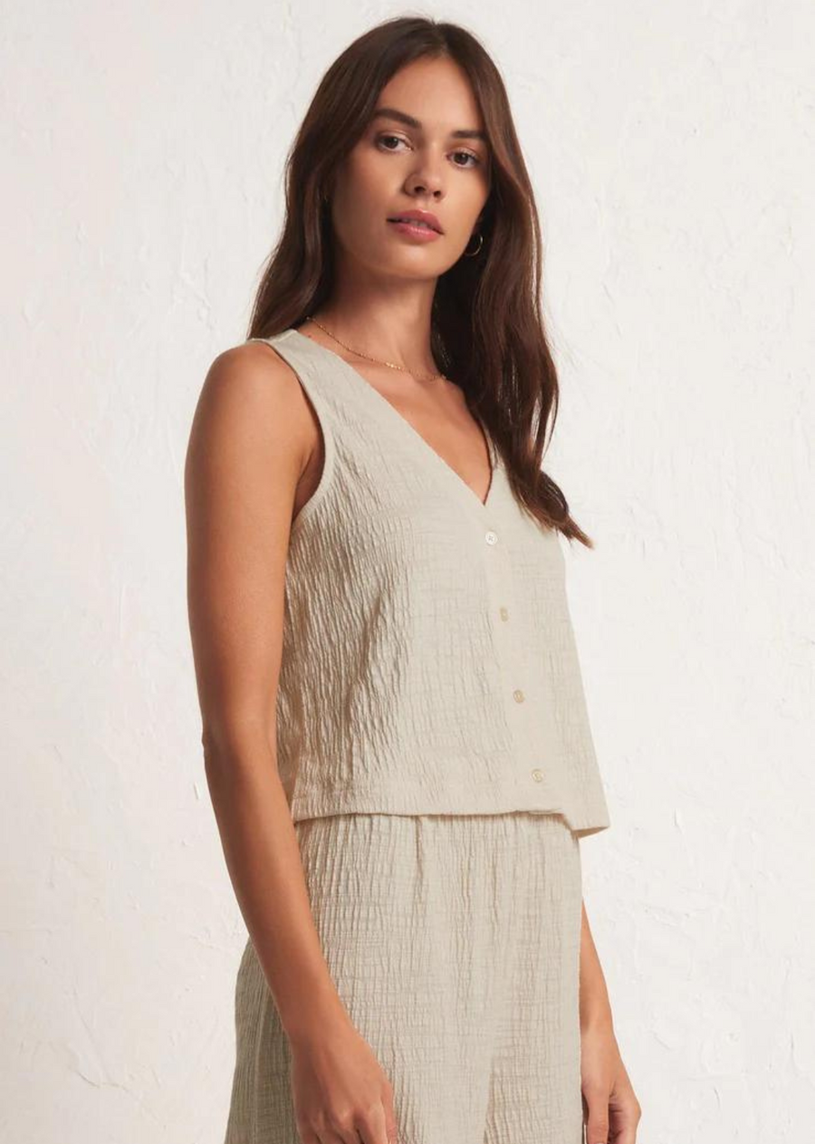 Z Supply Solace Textured Slub Top. When you're looking for a style that can go from professional to picnic in the park. This elevated textured slub button-front top features a sleeveless v-neck design and flattering relaxed fit.