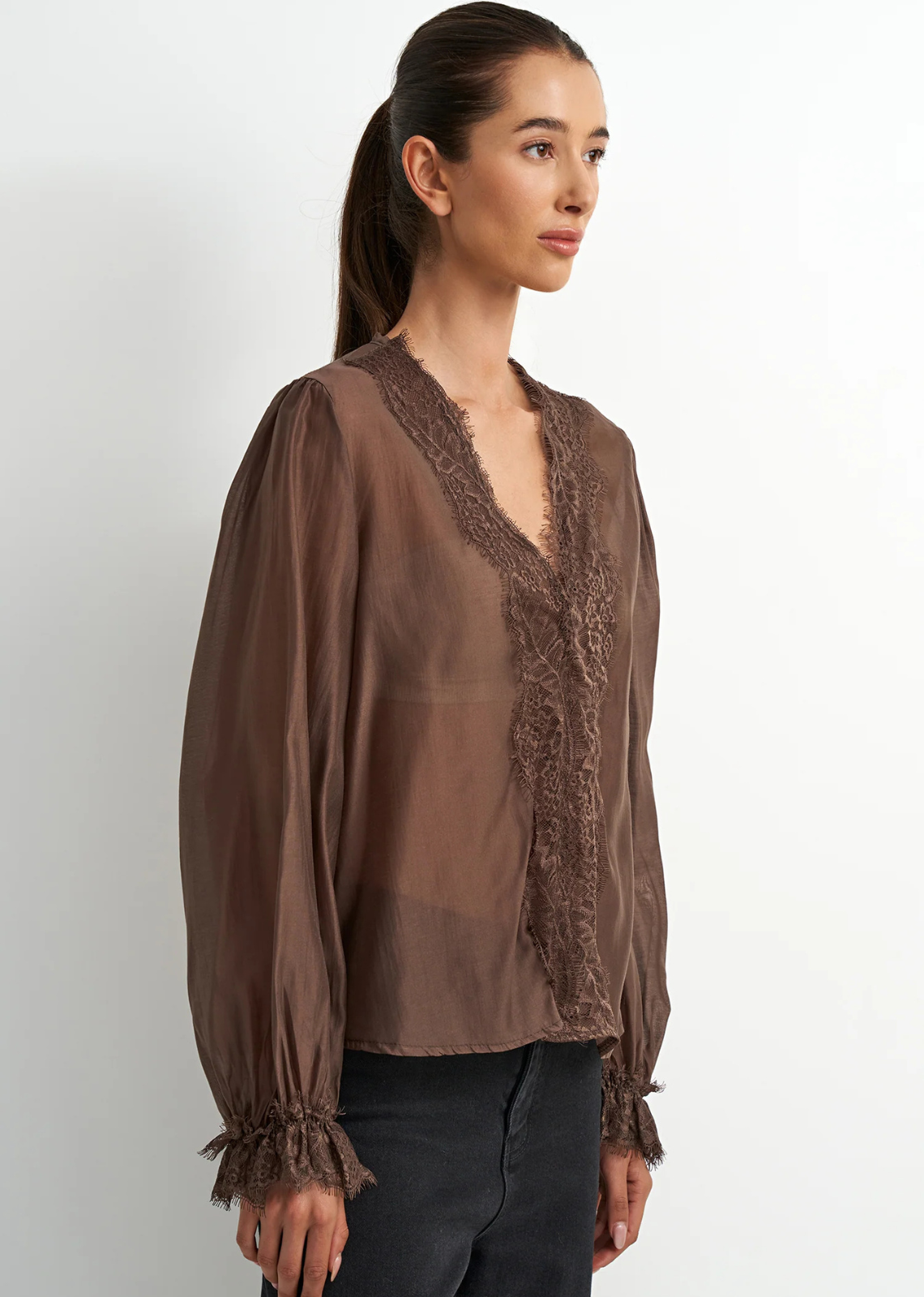 Brown lyocell-blend blouse with soft draping, feminine detailing, and a flattering silhouette, designed with a subtle Western-inspired aesthetic.