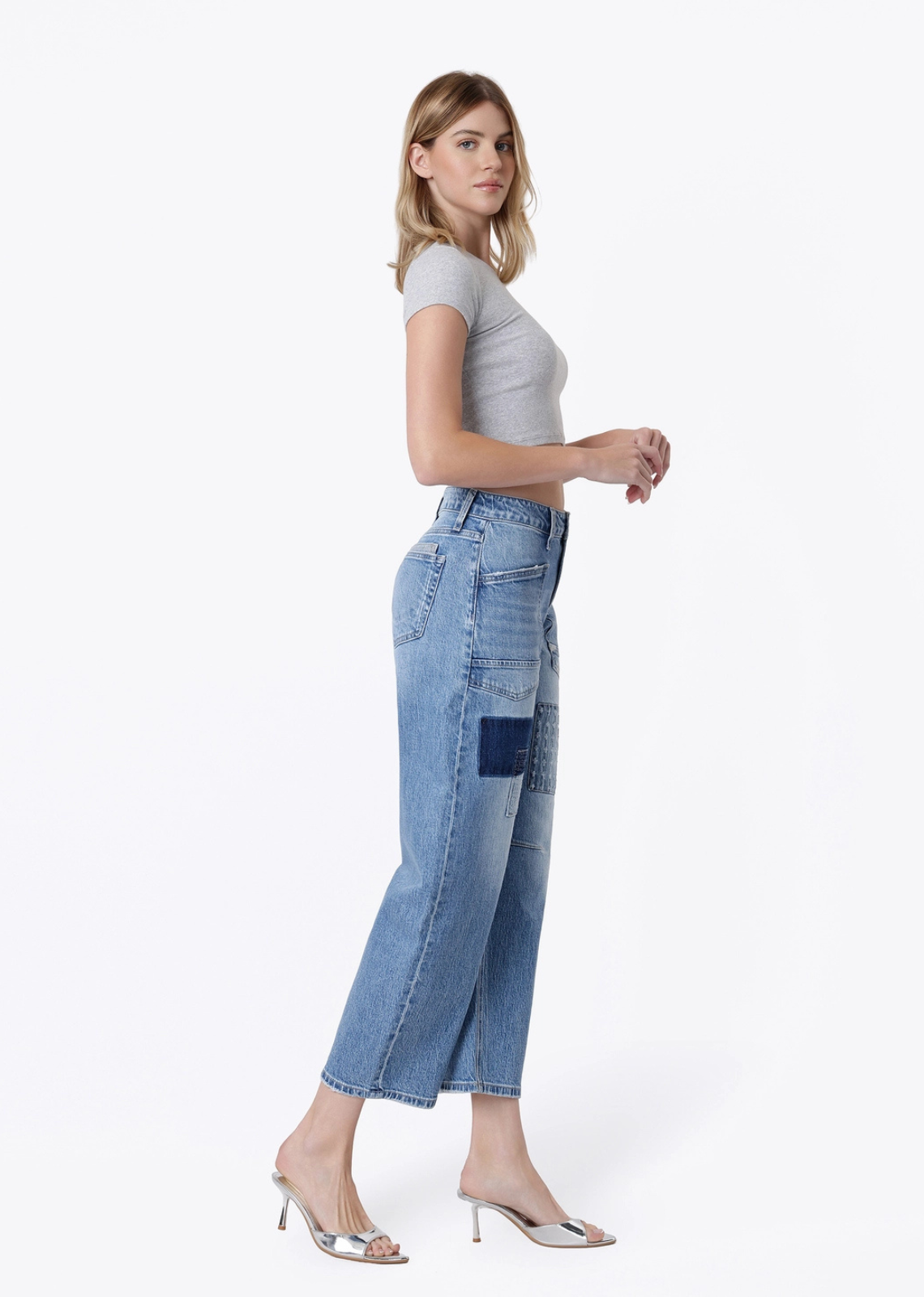 The Oakley patchwork barrel jeans in a medium-light wash, featuring a high-rise waist, patch pockets, cropped barrel-leg silhouette, comfortable stretch denim, and finished hem.
