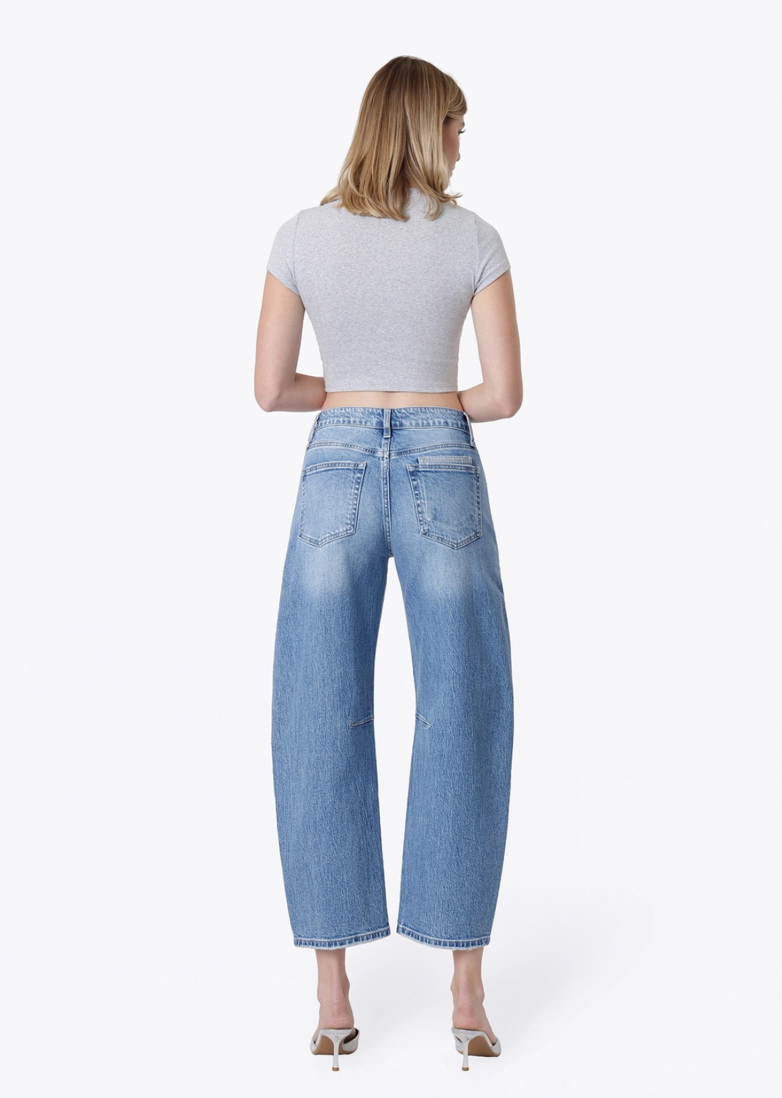 The Oakley patchwork barrel jeans in a medium-light wash, featuring a high-rise waist, patch pockets, cropped barrel-leg silhouette, comfortable stretch denim, and finished hem.
