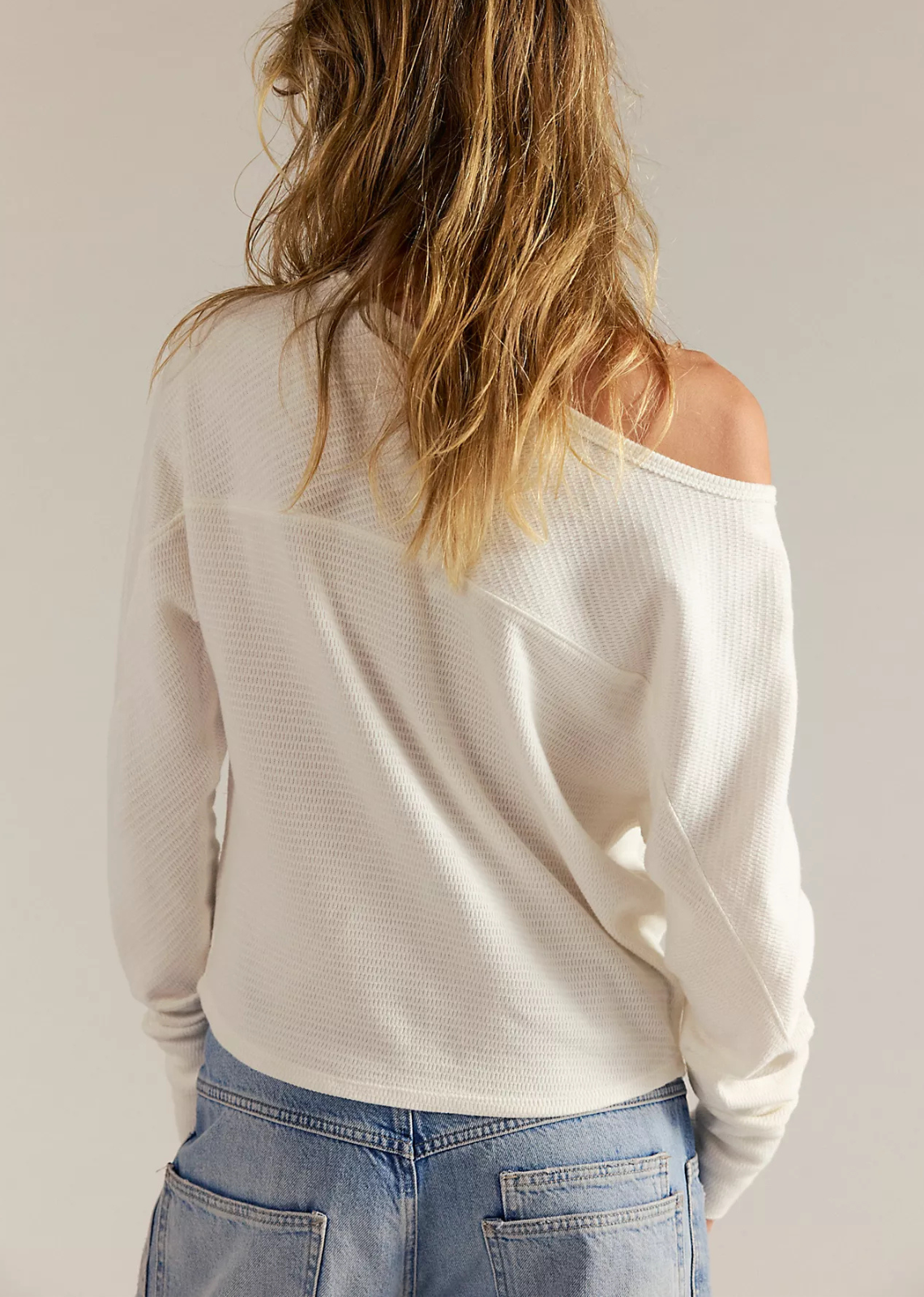 A cozy, textured long-sleeve cotton-blend top with a flattering boat neckline, relaxed dolman sleeves, seamed detailing, and elongated cuffs.