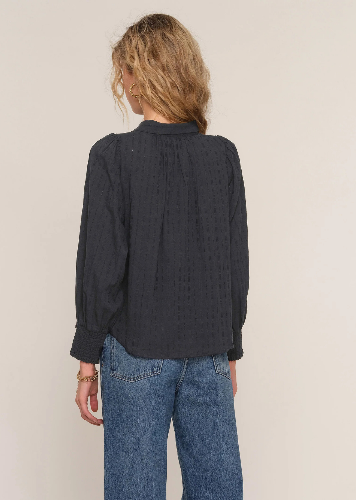 Washed cotton voile top with a relaxed fit, dot jacquard texture, button-down front, and blouson sleeves.