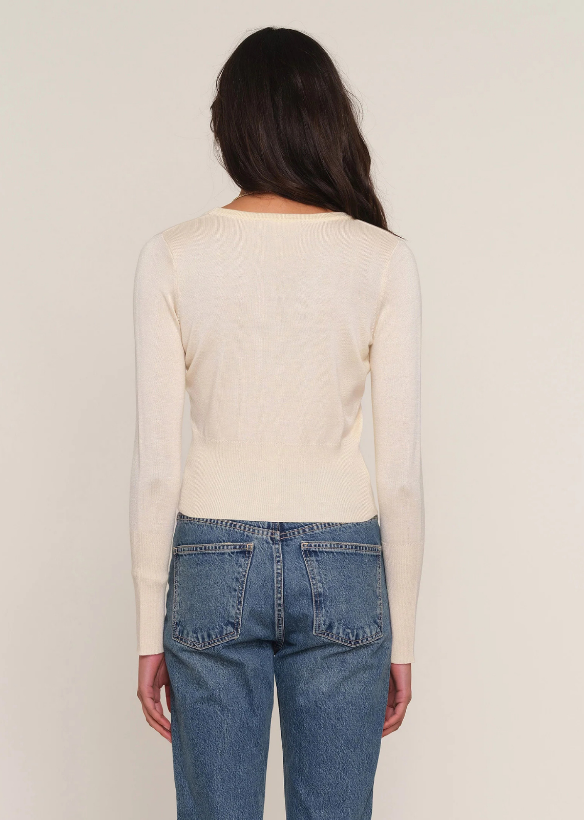 Slim-fit ribbed knit cardigan featuring a V-neckline, self-covered buttons, and ribbed hem.