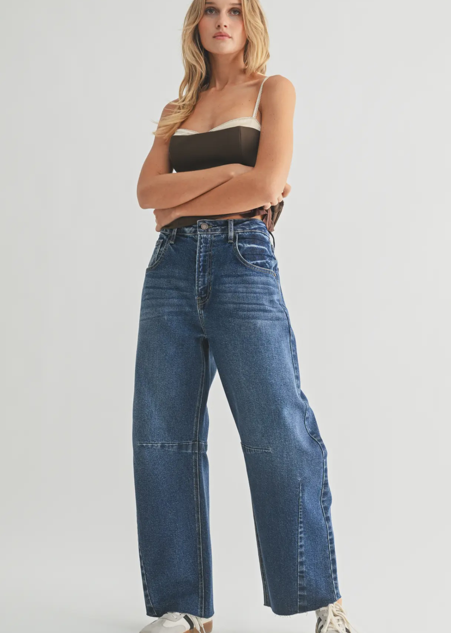 Meet the jeans everyone will be asking about. The Kaia Barrel Jean features an exaggerated wide-leg barrel silhouette with statement seam detailing for an effortlessly cool, on-trend look.&nbsp;

Designed with a flattering&nbsp;12" high rise, 27" inseam, and 10" leg opening, this jean is finished in a versatile dark denim wash that easily takes you from everyday looks to nights out.