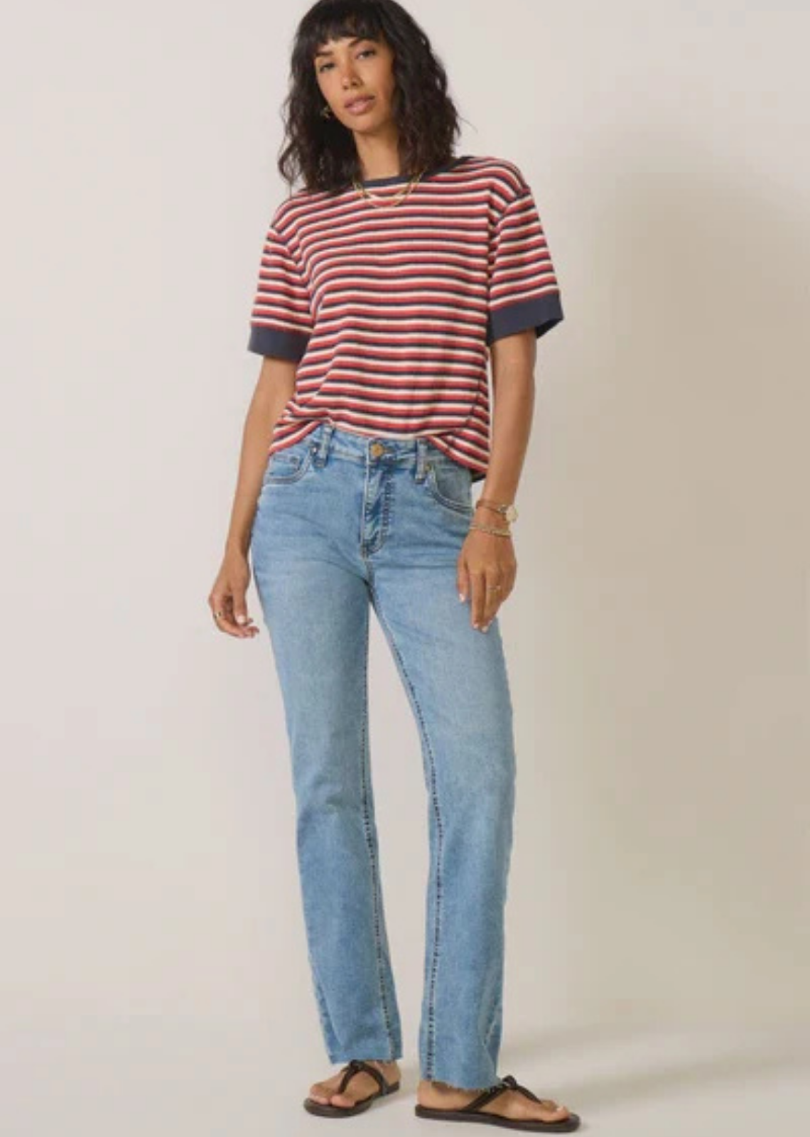KUT from the Kloth Kelly high-rise flare jeans in a light-to-medium blue wash, featuring a slim fit, subtle flare, stretch denim, classic five-pocket styling, and raw-cut hems.

