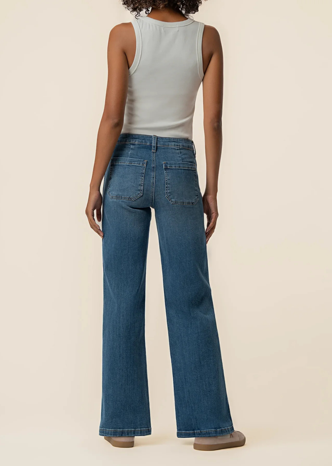 High-rise medium-wash wide-leg jeans featuring scoop pockets and stretch denim for a comfortable everyday fit.