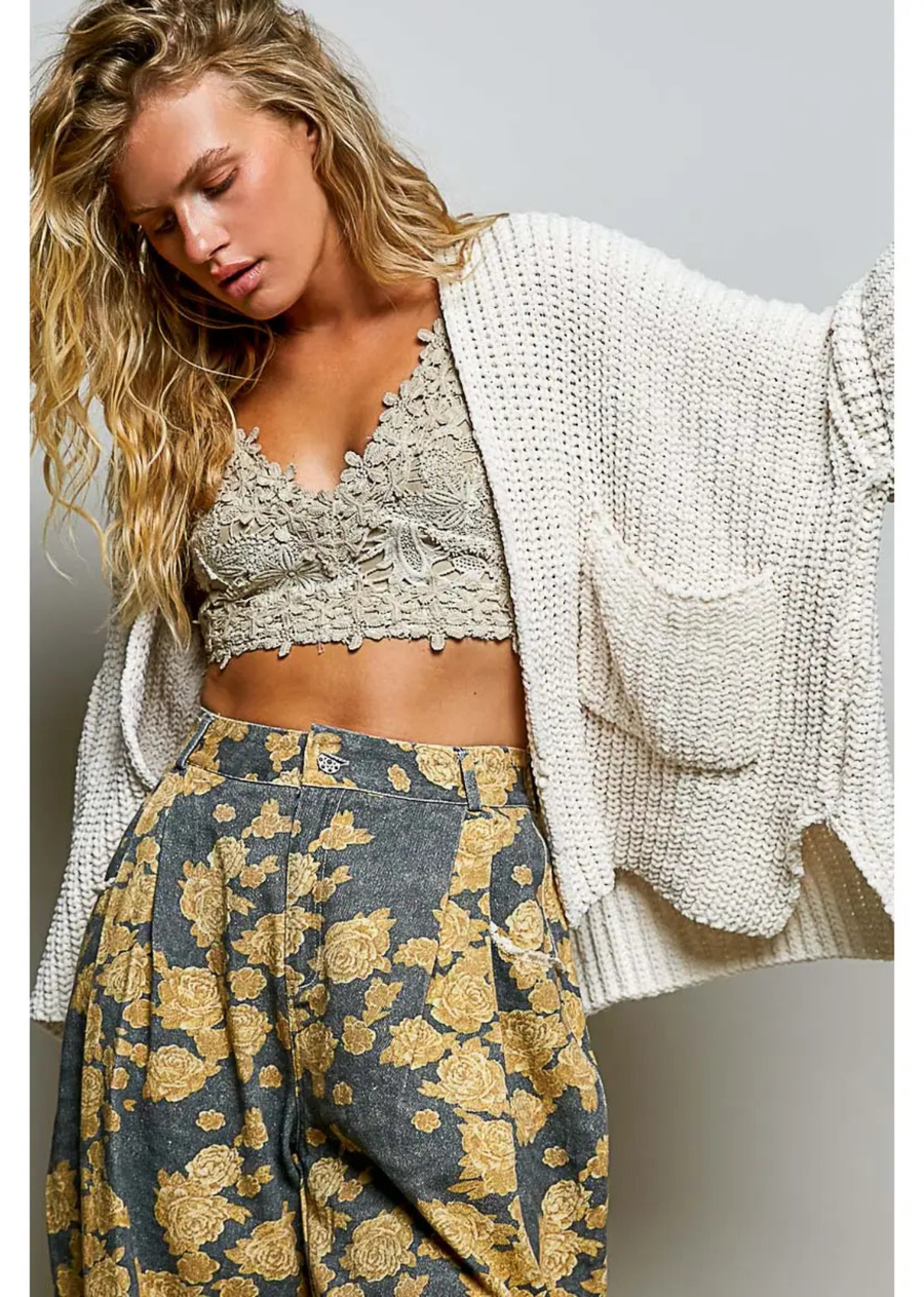 cream open-front cardigan with a relaxed oversized fit, textured knit, long sleeves, and side pockets. Approx. 25.5" in length.