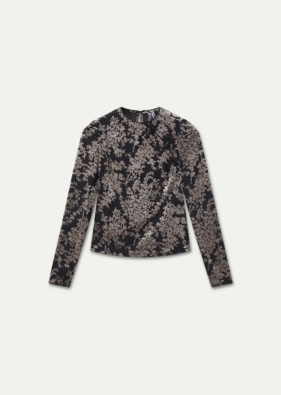Black and white devoré top with a round neckline, long sleeves, floral knot detail, and back button closure.