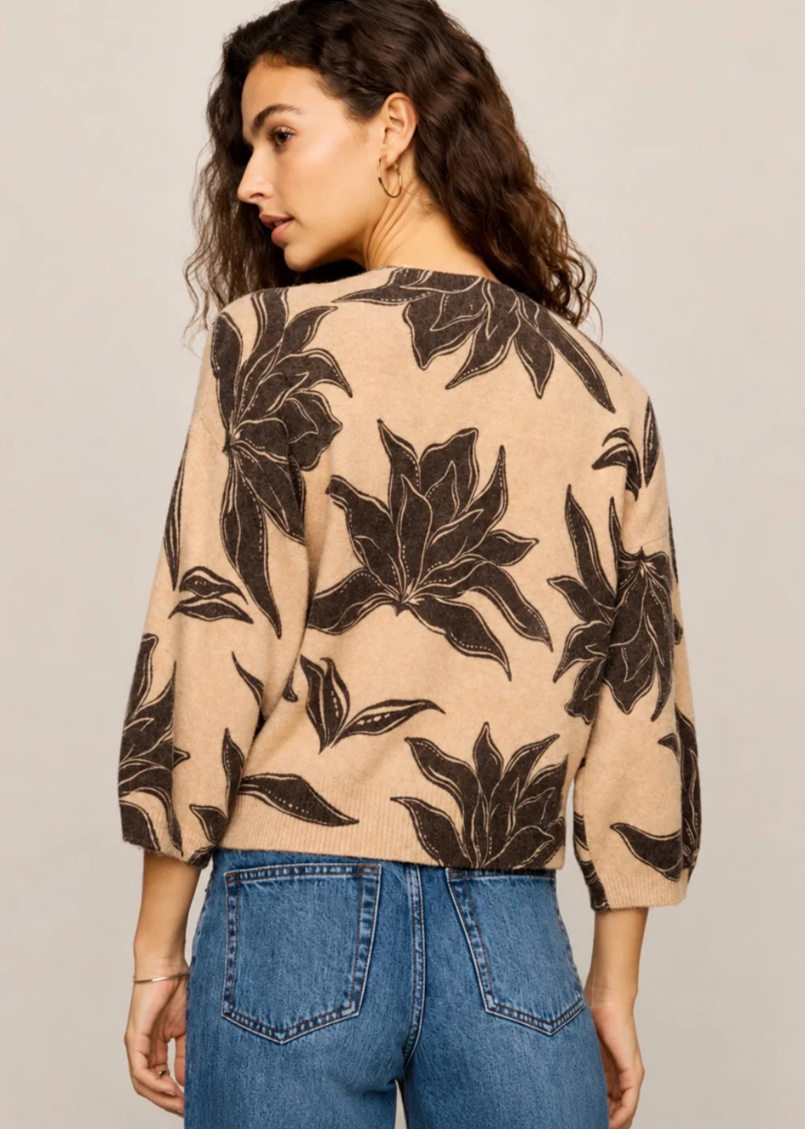Floral print cardigan with a crew neckline, button-front closure, and 3/4-length balloon sleeves in a soft, lightweight knit.

