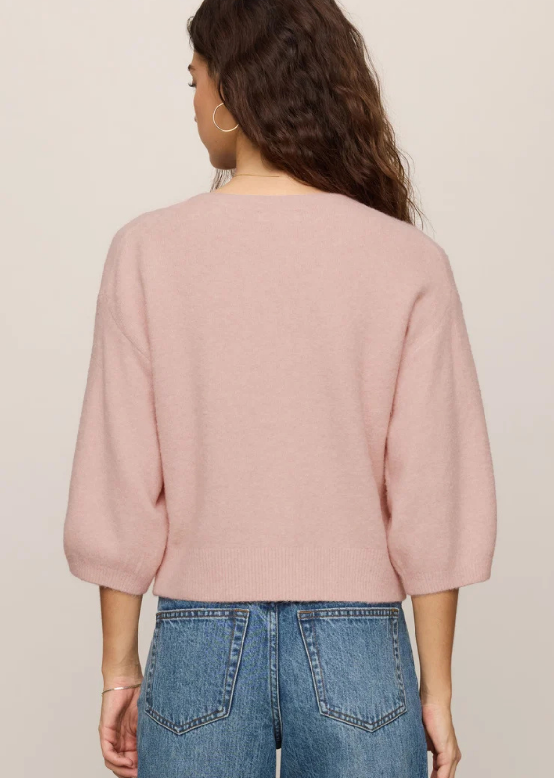 Lightweight knit cardigan with a crew neckline, button-front closure, and 3/4-length sleeves in a soft, cozy yarn blend.