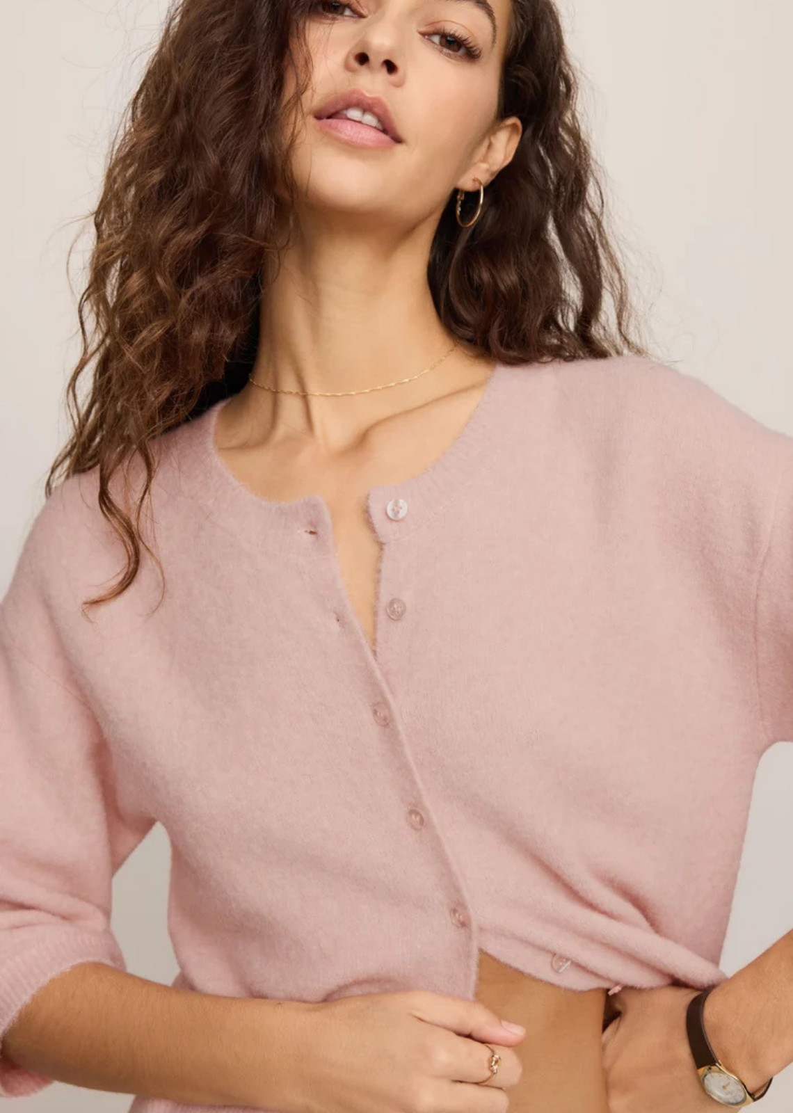 Lightweight knit cardigan with a crew neckline, button-front closure, and 3/4-length sleeves in a soft, cozy yarn blend.