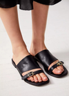 Free People Mila Minimal Flat Sandal. Sure to be your go-to sandal all season long, this staple shoe is featured in a classic, slip-on silhouette and luxe leather fabrication with defined buckle detailing for an added special touch.