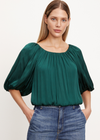 Velvet Tami Satin Top. Crafted from satin viscose with a subtle sheen, this cropped top features exaggerated puff sleeves for a bold and modern look. The elastic neckline, cuffs, and hem offer versatile styling, allowing you to wear it on or off the shoulder.