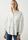 Rails Janae Shirt Look polished from work to weekend in this feminine take on the classic button-down shirt. Made from lightweight cotton poplin, this crisp collared button-down shirt comes in an oversized fit and features a dropped shoulder, patch pocket at chest, and full sleeves with shirring.
